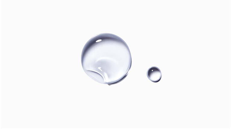 Two clear water droplets on a white background, one larger and one smaller, showcasing their round shapes and reflections.