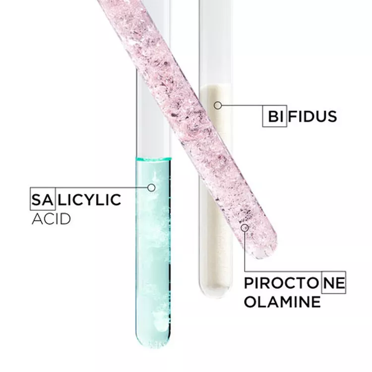 Three test tubes containing different substances: one with salicylic acid (light blue), one labeled bifidus (pink), and another with piroctone olamine (white). Each tube is clearly marked with its respective name.