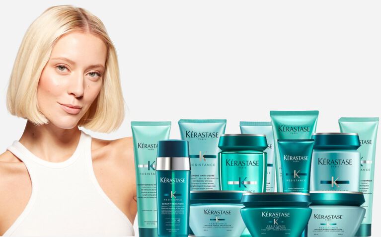 Kerastase Resistance model with hair care products for damaged hair