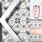 A close-up of a silver letter "K" set against a patterned background featuring hearts and geometric designs, alongside two Kerastase hair care products in pink bottles.