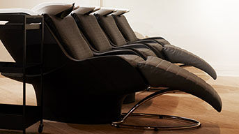 Alt text: A row of salon shampoo chairs against a light background, with the text "IN SALON SERVICES" displayed beside them.