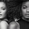 A black and white portrait of two women standing back to back, showcasing different hairstyles—one with wavy hair and the other with voluminous curls. Both have natural makeup, highlighting their features.