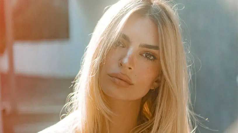 A close-up portrait of a woman with long, blonde hair, looking directly at the camera with a natural expression.