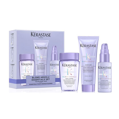 A Kerastase Blond Absolu essentials set featuring purple packaging and four hair care products for blonde hair.