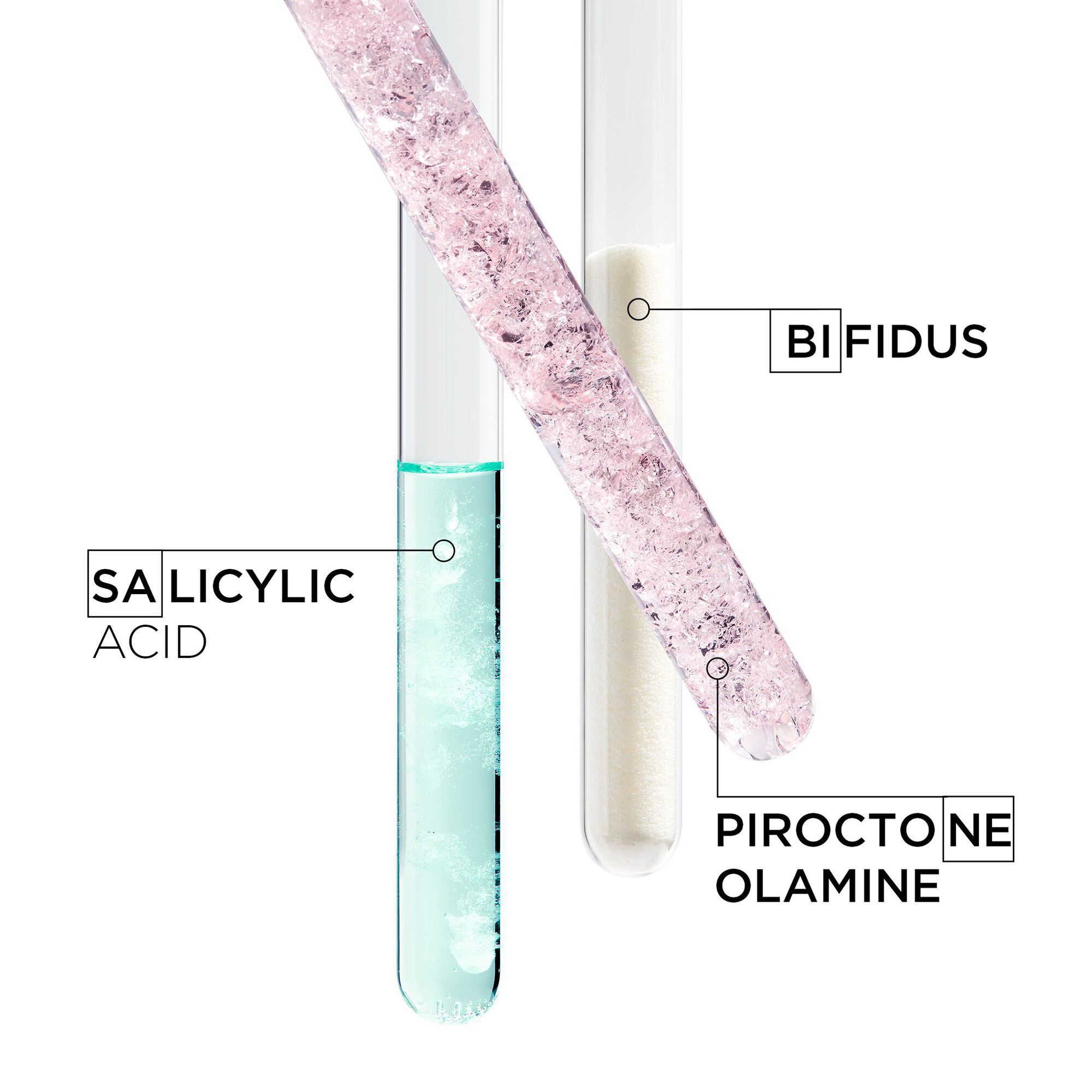 A close-up image of two test tubes containing different substances: one with aqua-colored liquid labeled "Salicylic Acid" and another with a white powder labeled "Piroctone Olamine," with a third label indicating "Bifidus."