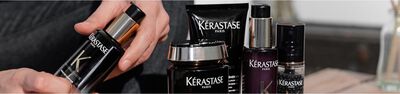 A close-up of various Kerastase Paris hair care products, featuring sleek black packaging with the brand's logo prominently displayed.