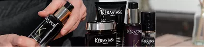 A close-up of various Kerastase Paris hair care products, featuring sleek black packaging with the brand's logo prominently displayed.