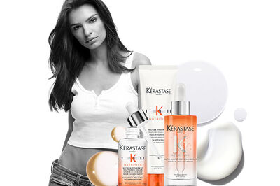 A model is featured alongside various hair care products from Kerastase, including oils, a treatment, and a cream, set against a light background.