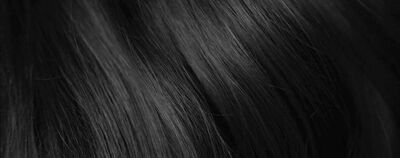 Close-up of smooth, straight black hair strands with gentle waves.
