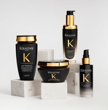 CHRONOLOGISTE RANGE SHOT OF FOUR BLACK AND GOLD BOTTLES ON A PODIUM