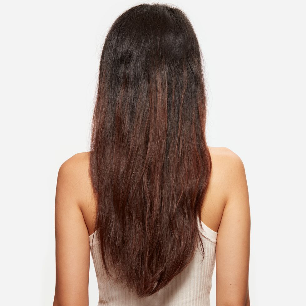 Close-up of hair with split ends showing dry, damaged strands, illustrating the importance of hair care and treatment for preventing hair breakage