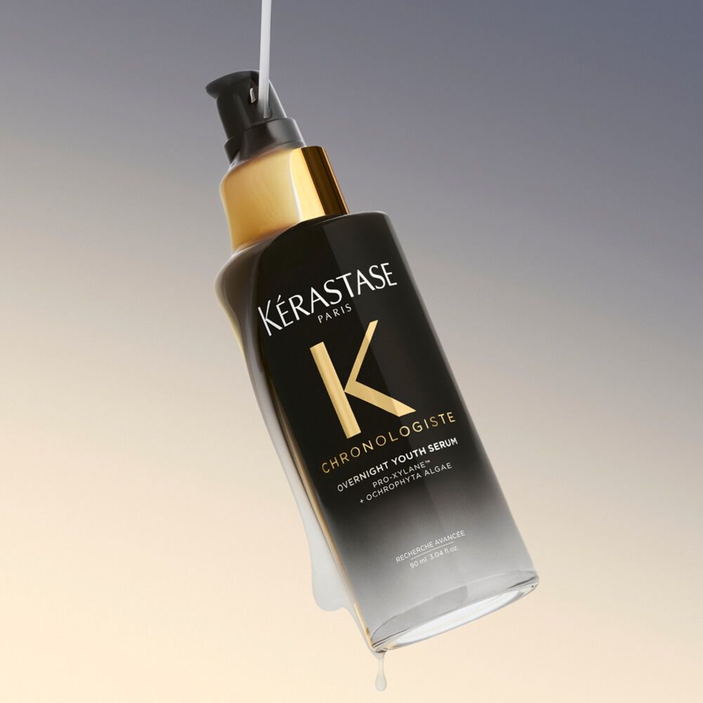 bottle of chronologiste hair serum on a gradient background from grey to beige
