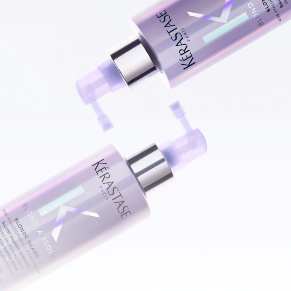 TWO purple bottles resting on top of each other sideways, it's the new blond absolu product called blonde guard by kerastase