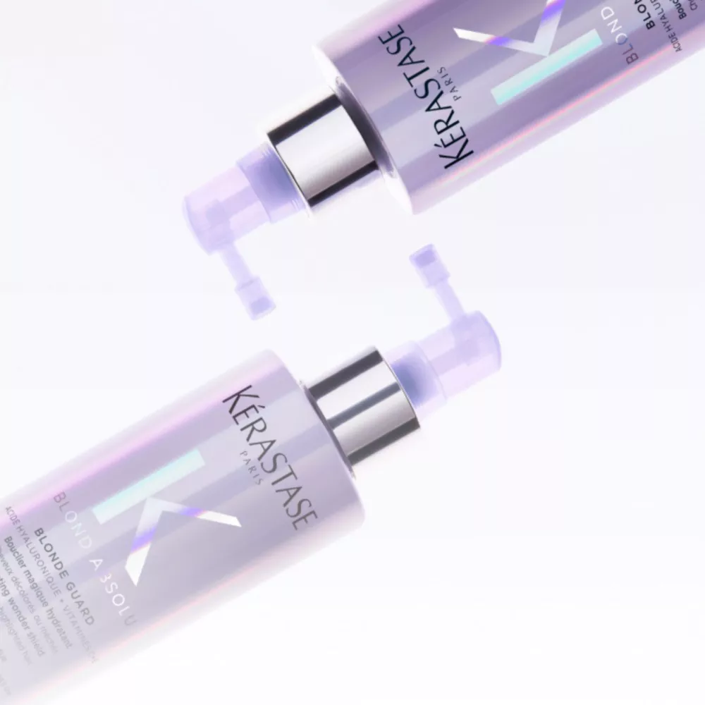 TWO purple bottles resting on top of each other sideways, it's the new blond absolu product called blonde guard by kerastase