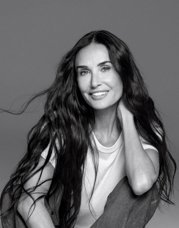 Demi Moore posing on a grey background