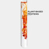 A clear test tube with swirling red and orange liquid, labelled \'Plant-Based Proteins.\'
