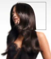 A woman with long, wavy hair poses in a white tank top, accentuated by digital light effects on her hair.