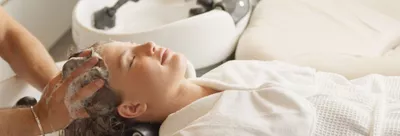 Customer having their hair washed with Kerastase in salon