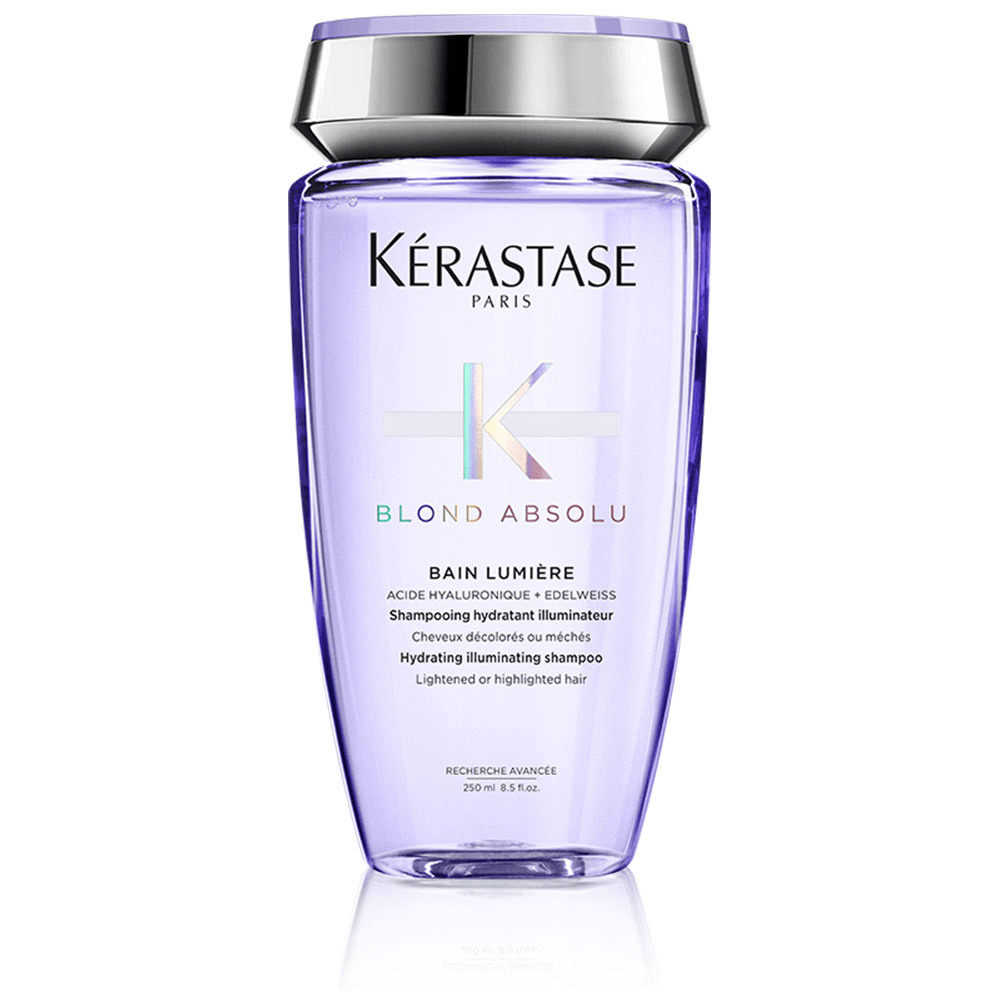 A bottle of Kérastase Blond Absolu Bain Lumière shampoo, designed for hydrating and illuminating lightened or highlighted hair.