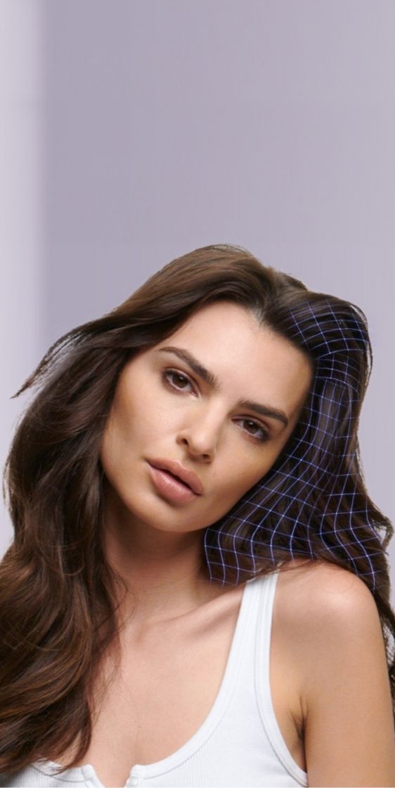 A woman with flowing brown hair, against a muted purple background. Text at the top reads FIND YOUR
HAIRCARE ROUTINE and it takes us to the hair diagnostic tool